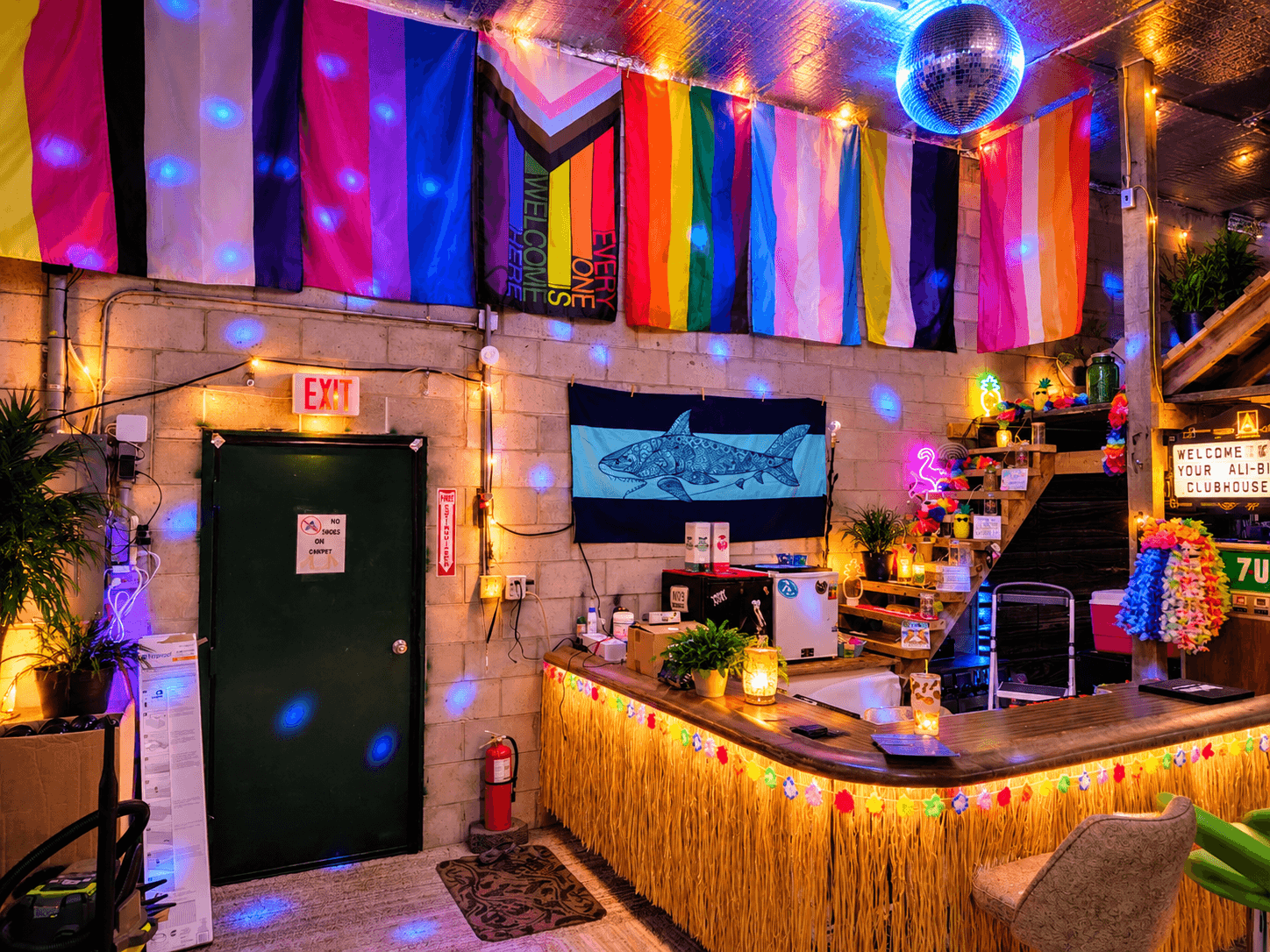 Your Ali-Bi Clubhouse bar area after dark with colorful party lighting