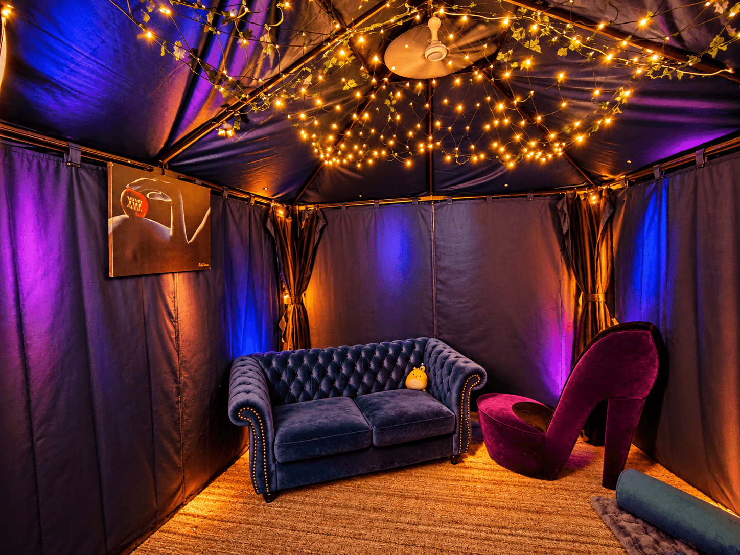 Private cabana lounge with soft string lighting inside the Your Ali-Bi Clubhouse